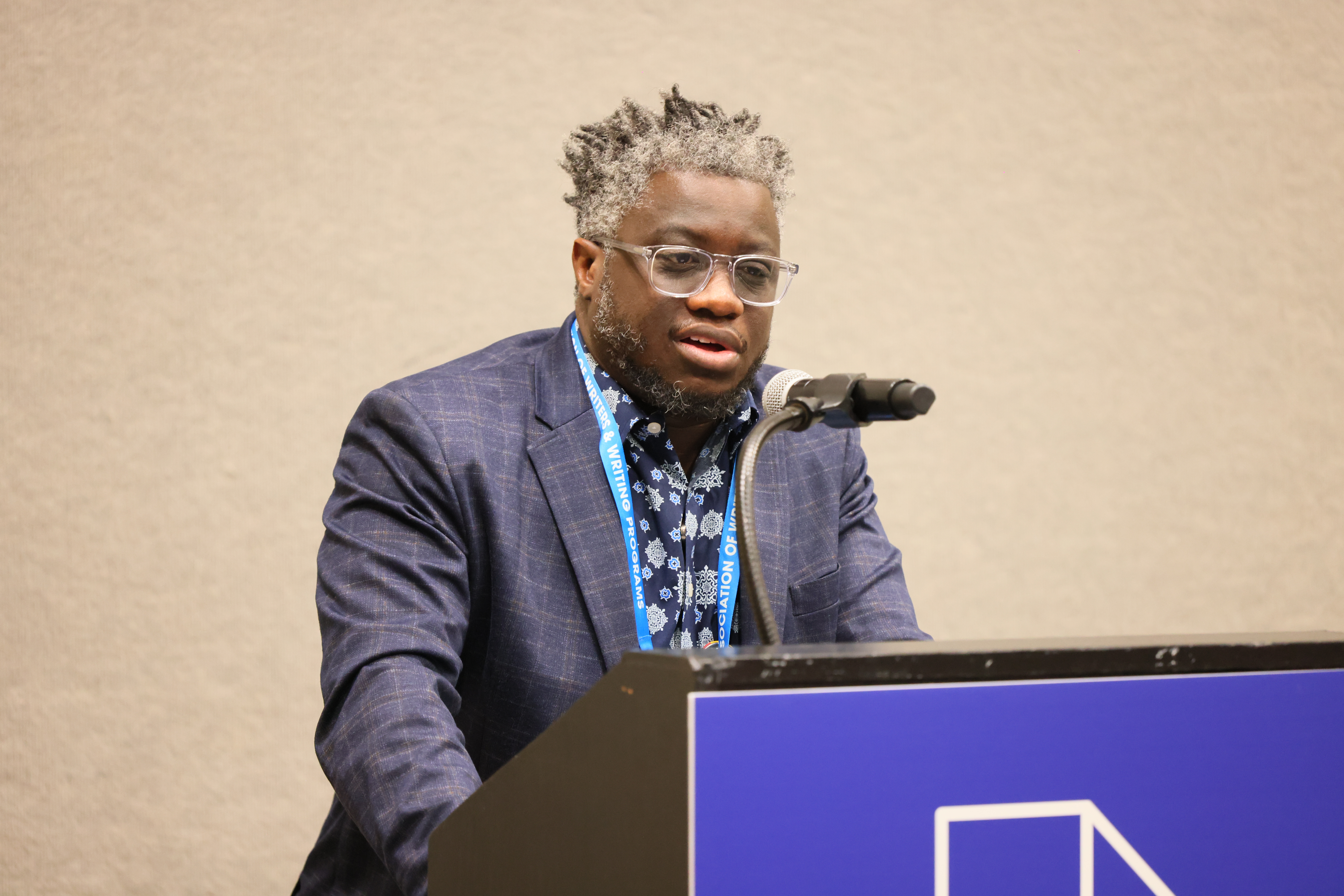 Creative advisor Rion Amilcar Scott speaking from a podium to #AWP24 HBCU fellows